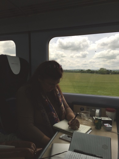 Rae writing on the train to Wales.jpg